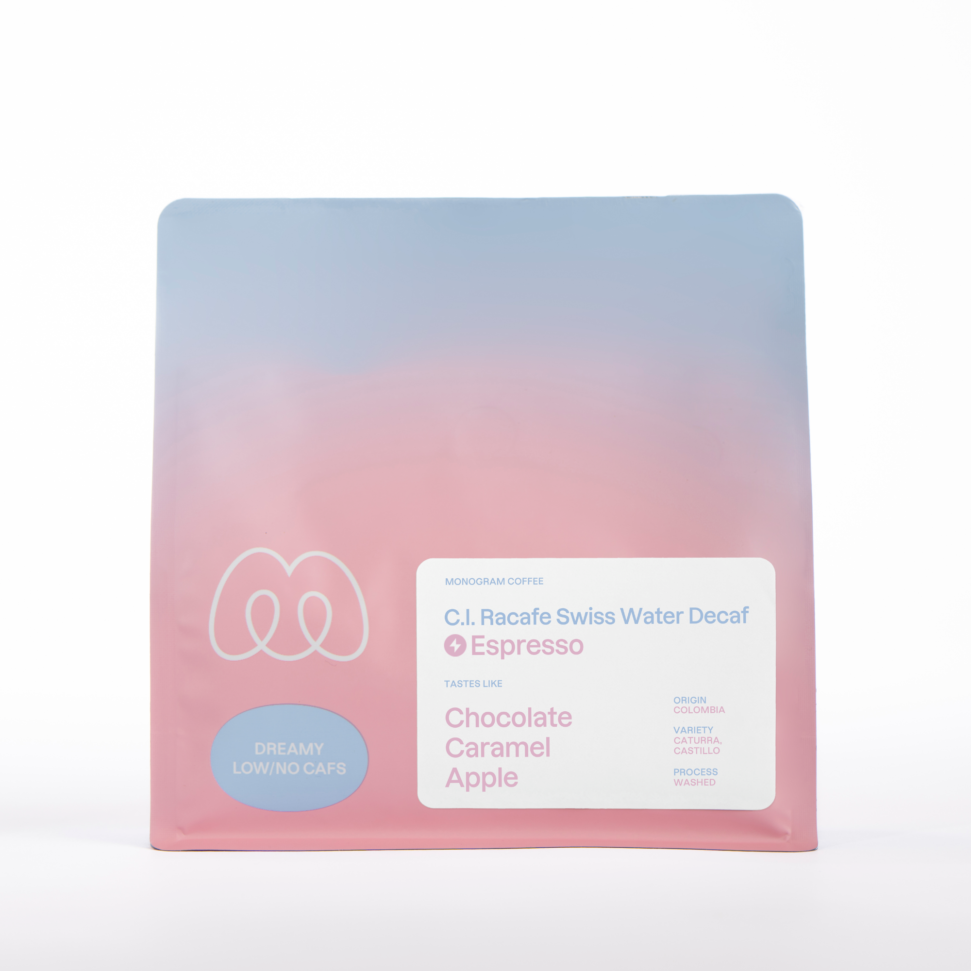 A blue and pink gradient bag of Monogram C.I. Racafe espresso coffee, a Swiss Water Process decaf from Colombia (Washed Caturra and Castillo) with tasting notes of chocolate, caramel, and apple.