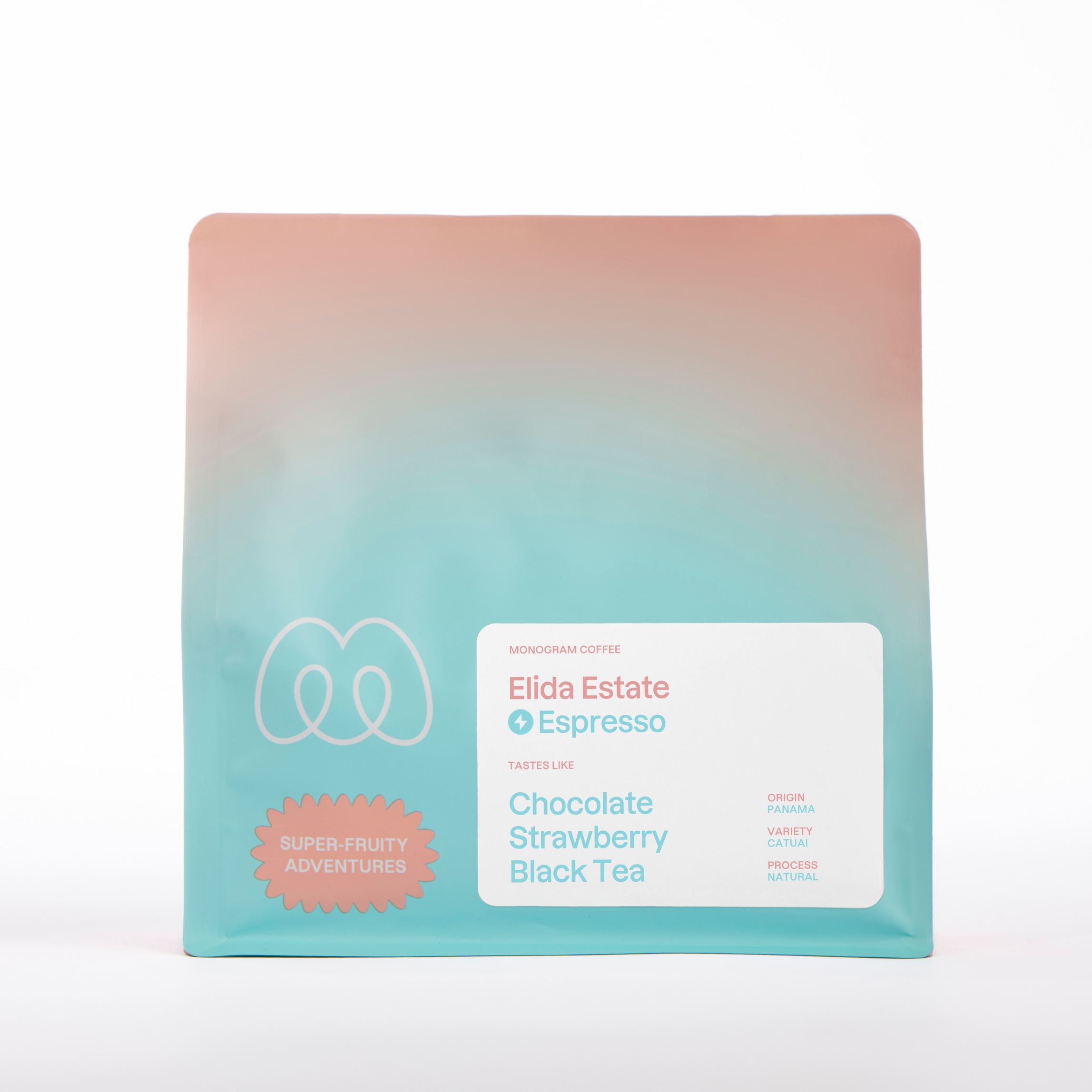 A teal and peach gradient bag of Monogram Elida Estate espresso coffee, a natural processed Catuai from Panama with tasting notes of chocolate, strawberry, and black tea.
