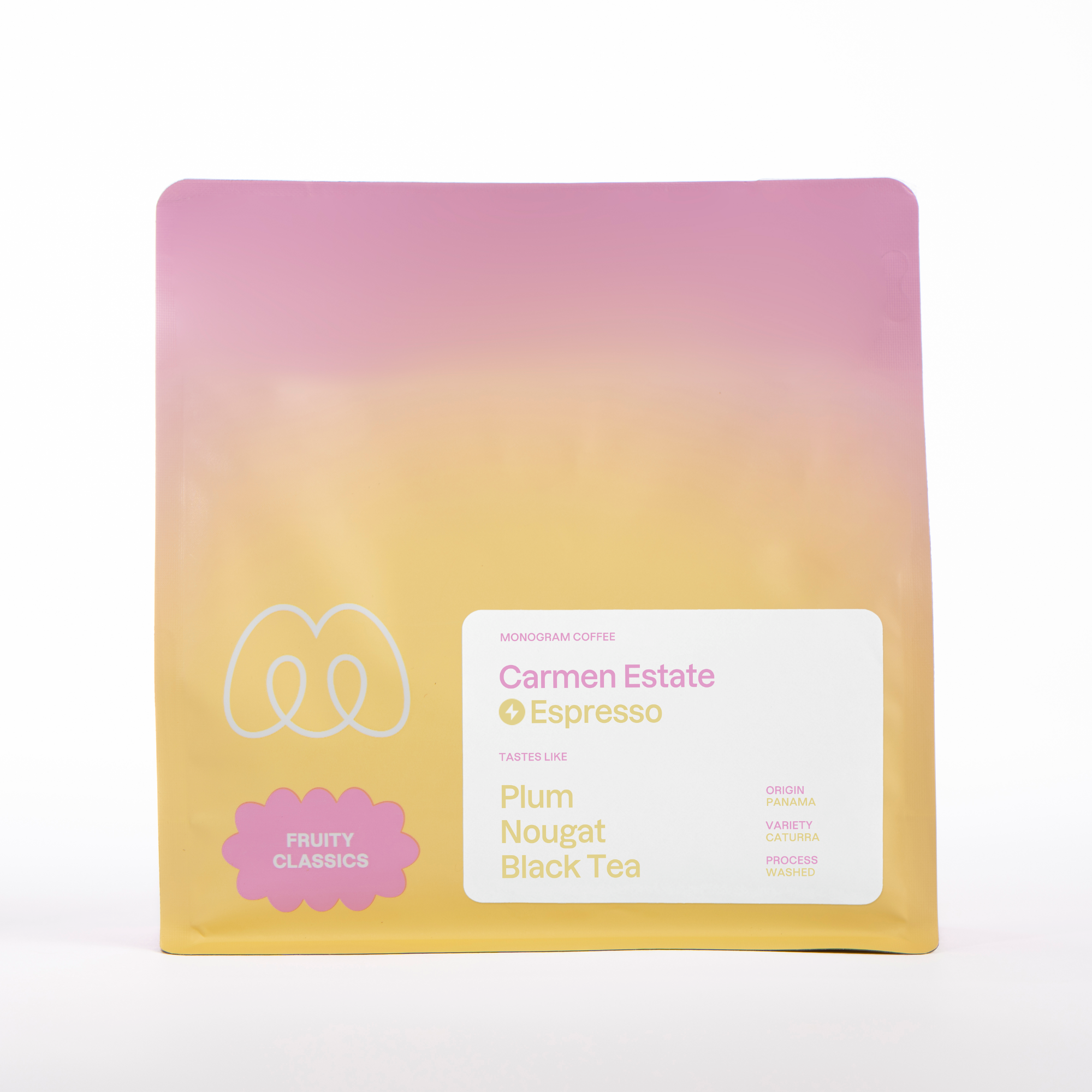 A bag of Monogram Carmen Estate espresso coffee, a washed Caturra from Panama with tasting notes of plum, nougat, and black tea in a pink and yellow gradient bag.