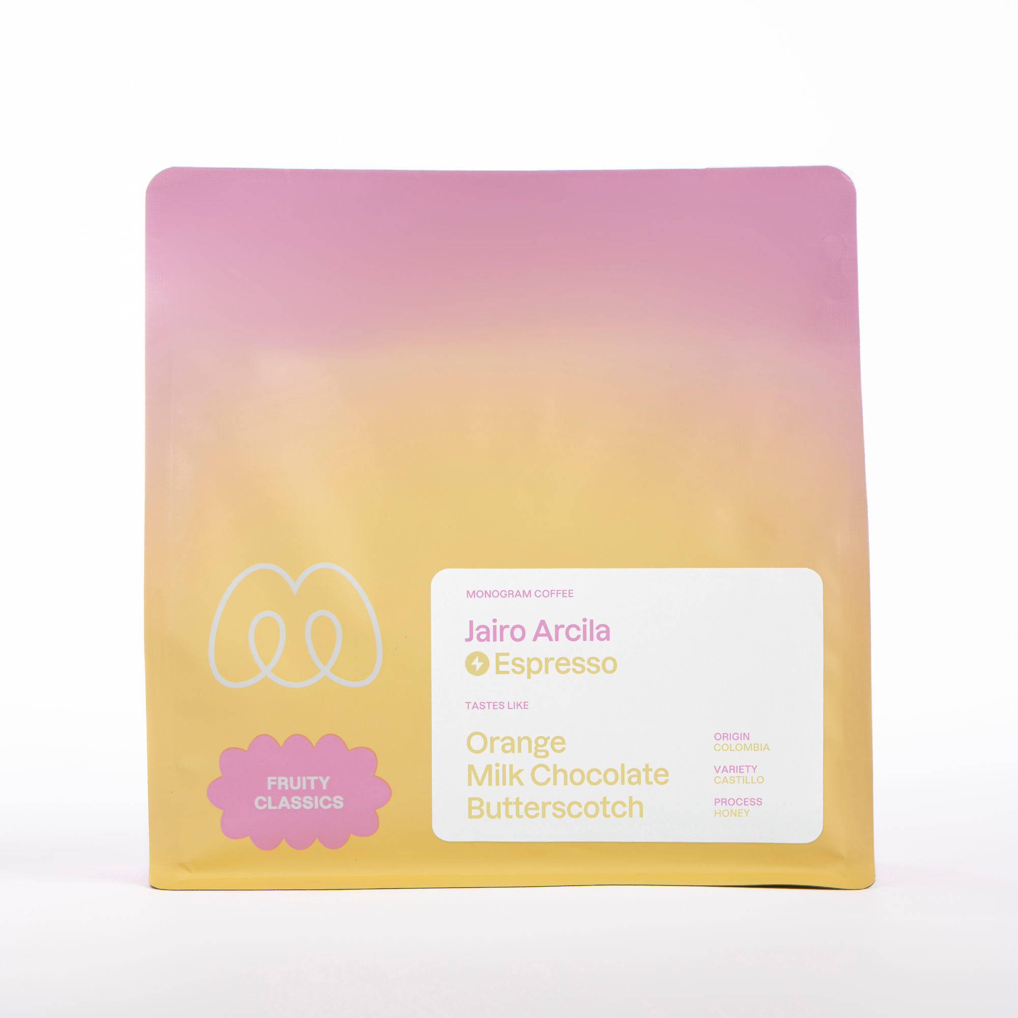 A pink and yellow gradient bag of Monogram Jairo Arcila espresso coffee, a honey-processed Castillo from Colombia with tasting notes of orange, milk chocolate, and butterscotch.